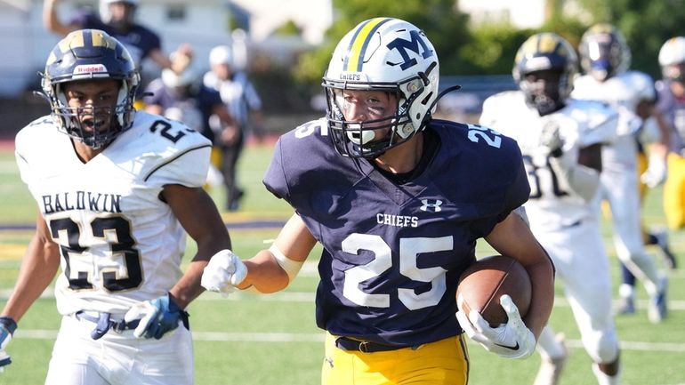 Tyler Villalta of Massapequa running for a touchdown against Baldwin...