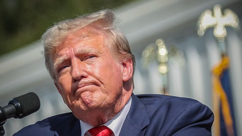 Former President Donald Trump pauses before ending his remarks at...