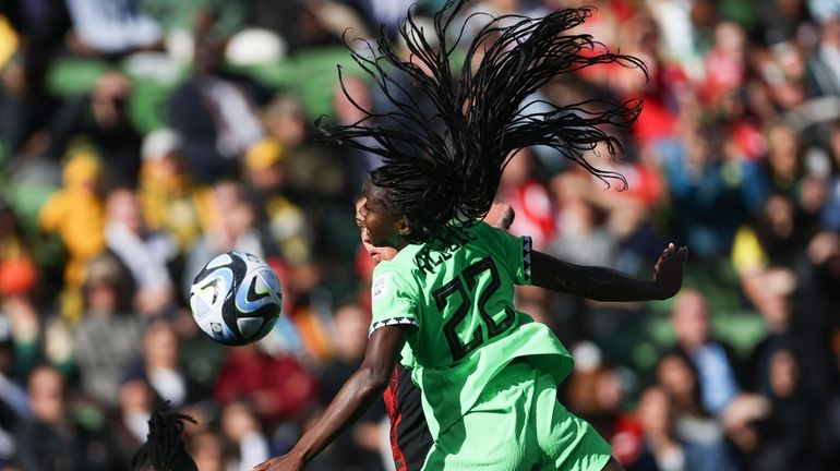 Nigeria's Michelle Alozie heads the ball during the Women's World...