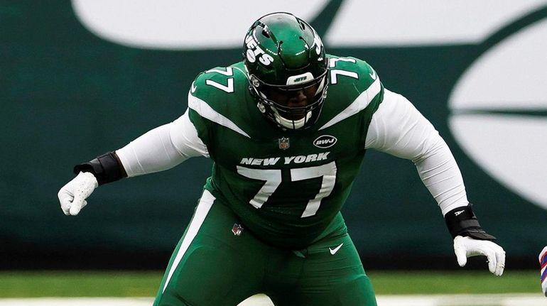 Jets offensive tackle Mekhi Becton blocks during an NFL game against...