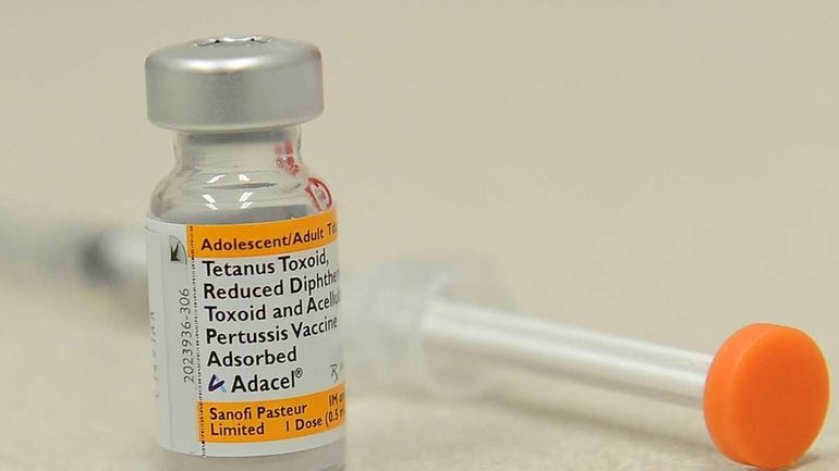 A bottle of the pertussis vaccine against whooping cough and...