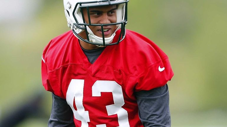 Cornerback Dexter McDougle of the Jets gets set to run...