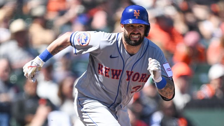 Tomas Nido of the Mets bunts in the eight inning of...