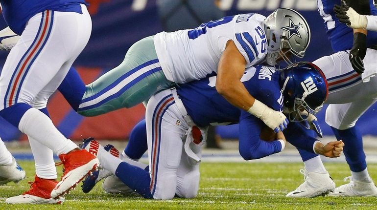 Tyrone Crawford of the Dallas Cowboys sacks Eli Manning at...