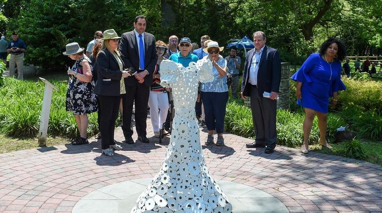 Holocaust survivor Meir Usherovitz, of St. James, center, at the Anne...