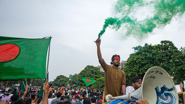 Students and other activists carry Bangladesh's national flag during a...