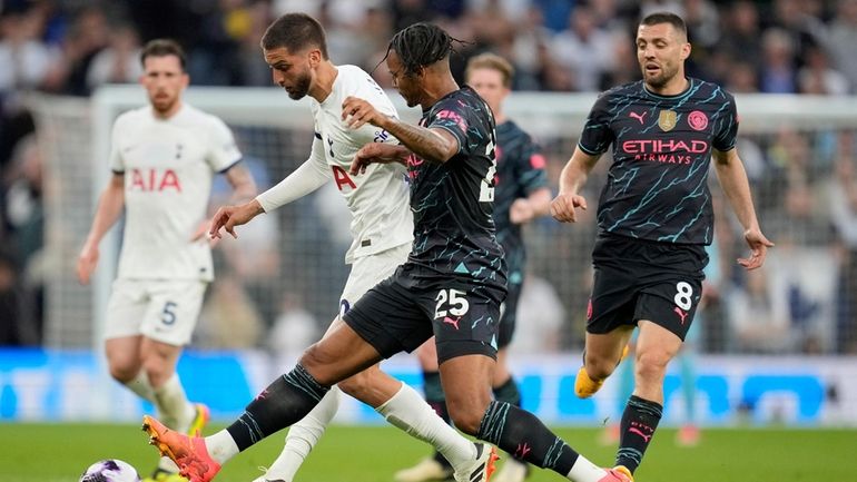 Tottenham's Rodrigo Bentancur, second left, and =Manchester City's Manuel Akanji...