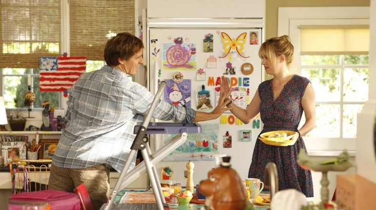 Nat Faxon, left, as Ben, and Dakota Johnson, as Kate,...