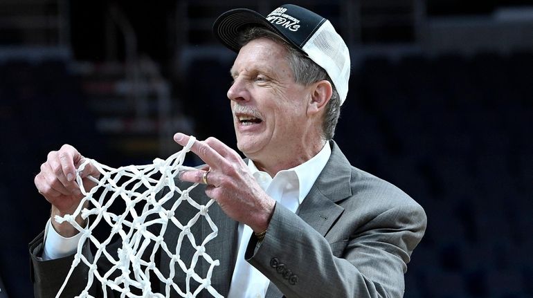 Iona head coach Tim Cluess holds a large section of...