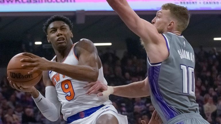 Knicks guard RJ Barrett drives to the basket as Kings forward...