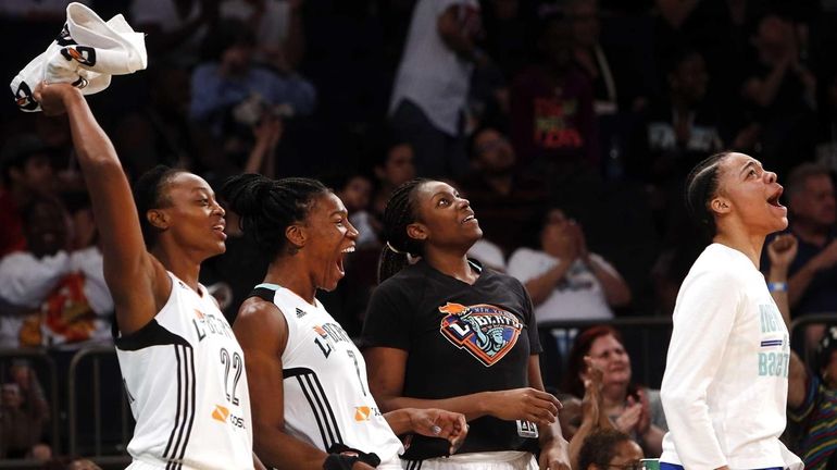 Players on the Liberty bench celebrate during the fourth quarter...