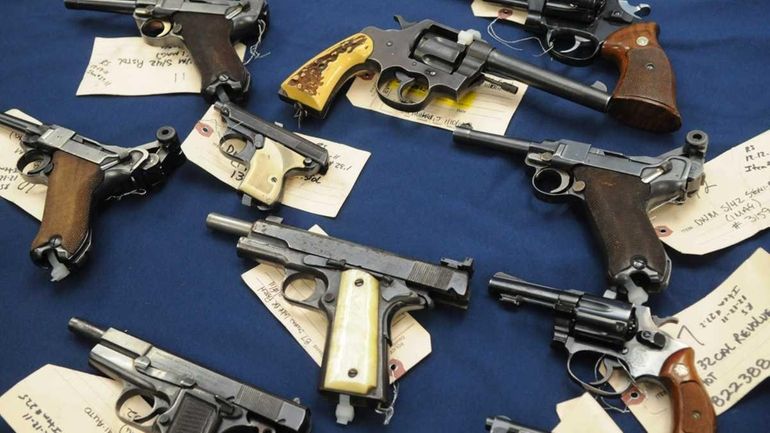 Illegal guns on display at the Suffolk County district attorney's...