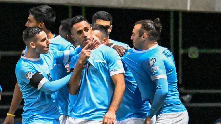 Israel's Eran Zahavi celebrates with teammates after scoring his side's...