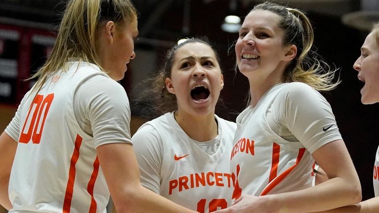 Princeton guard Grace Stone, second from left, celebrates with teammates...