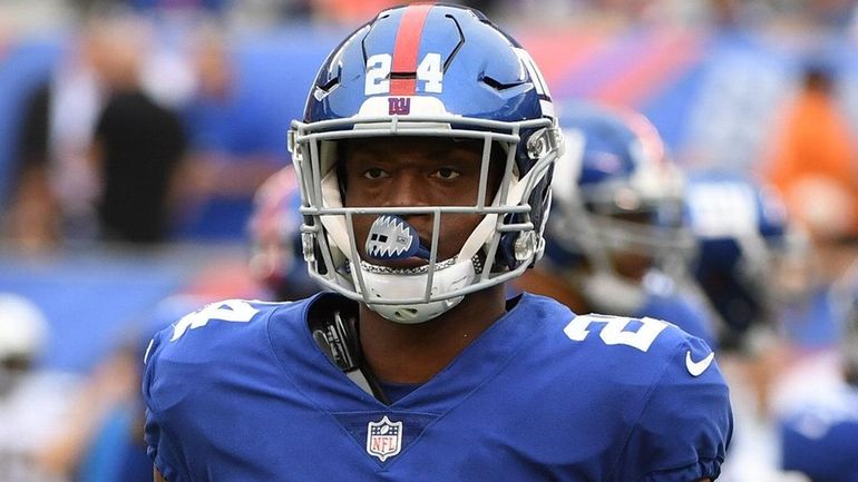 Giants cornerback Eli Apple looks on from the field against...