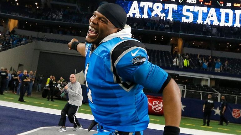 Carolina Panthers quarterback Cam Newton runs through the end zone...