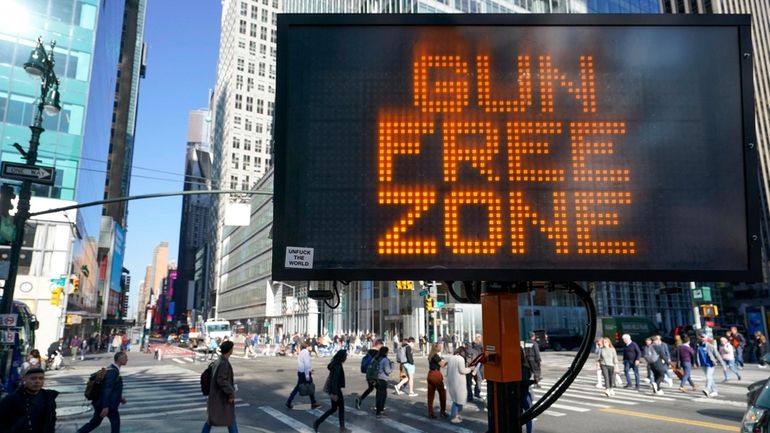 A traffic sign on the corner of 42nd Street and...