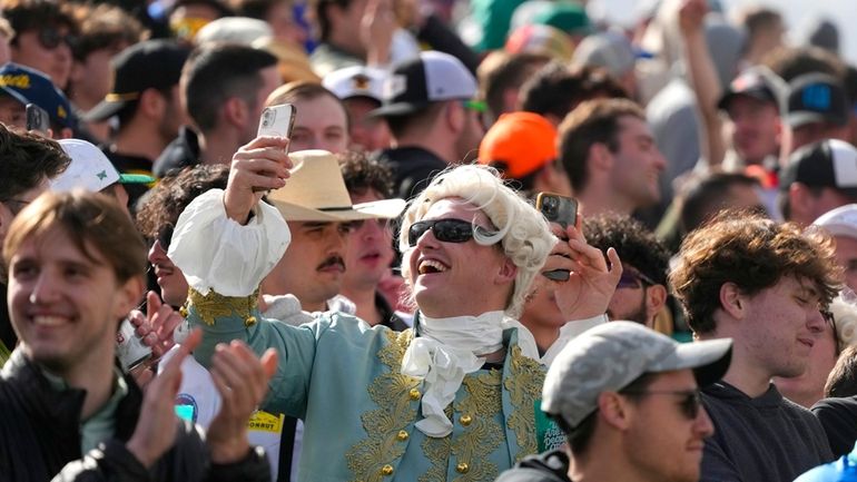 A member of the gallery at the 16th hole takes...