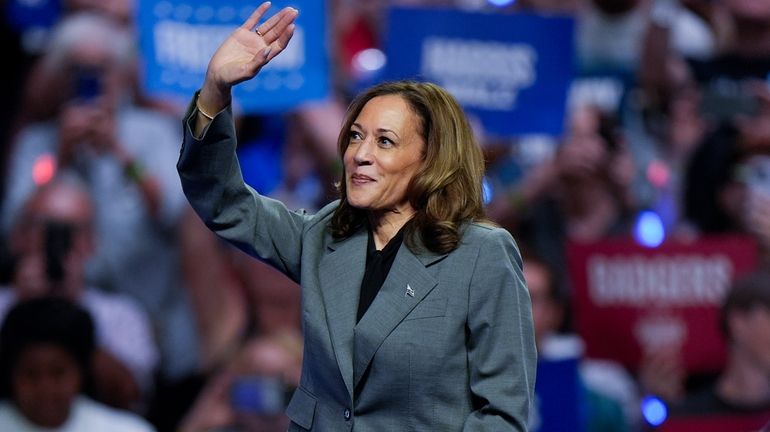 Democratic presidential nominee Vice President Kamala Harris waves to supporters...