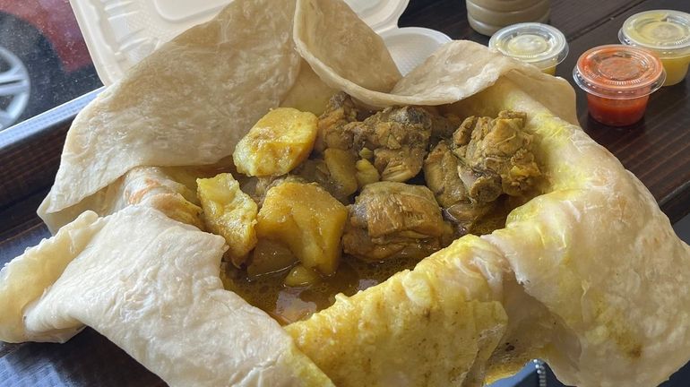 Curry chicken stuffed inside a roti at Homemade Kitchen Roti...