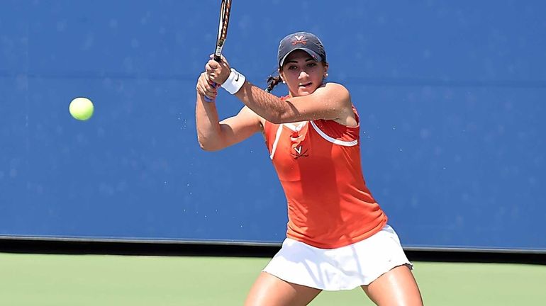 Julia Elbaba hits a backhand against Jamie Loeb in the...