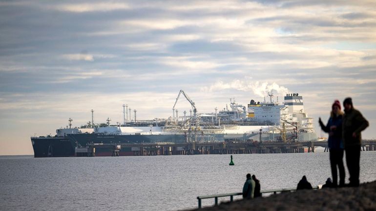 The tanker Maria Energy, left, loaded with liquefied natural gas,...