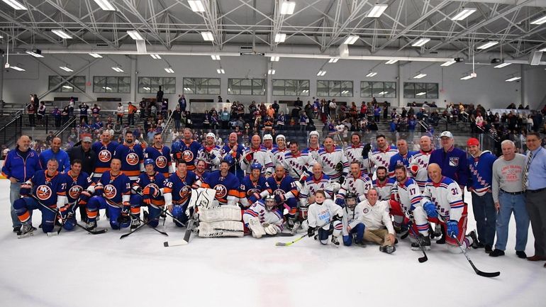 Alumni of the Islanders and Rangers pose for a photo...