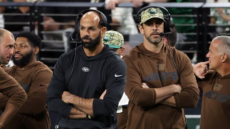 Jets head coach Robert Saleh and quarterback Aaron Rodgers watch...