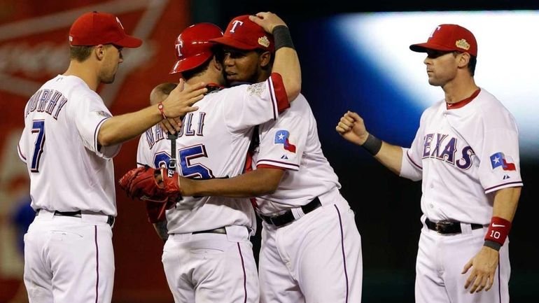 Mike Napoli and Neftali Feliz of the Texas Rangers celebrate...