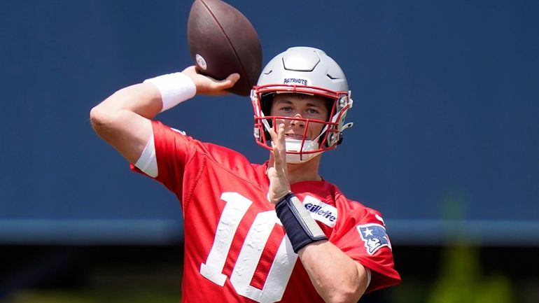 FILE - New England Patriots quarterback Mac Jones takes part...