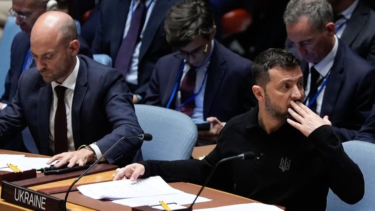 Ukraine President Volodymyr Zelenskyy, right, attends a Security Council meeting,...