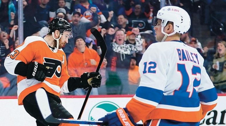 Philadelphia Flyers' Kevin Hayes, left, celebrates past Islanders' Josh Bailey after...