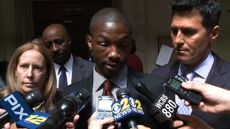 Kyle Howell, 20, of Westbury, speaks with the media after...