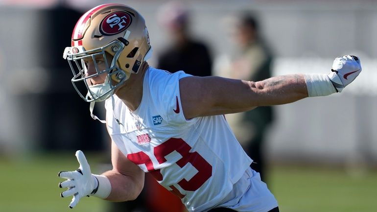 49ers running back Christian McCaffrey warms up during practice in Santa...