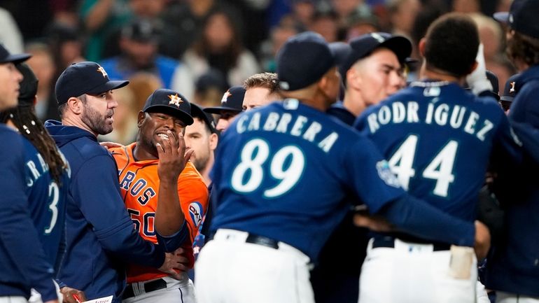 Houston Astros relief pitcher Hector Neris (50) gestures to Seattle...