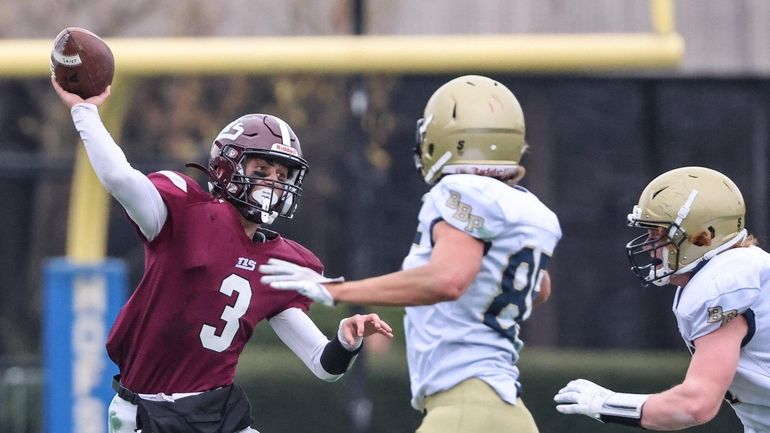 North Shore quarterback Peter Liotta passes under pressure during the...