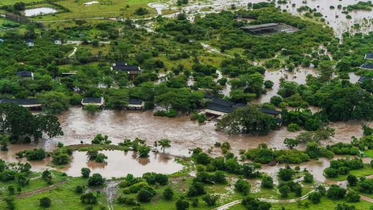 Aerial view of flooded Maasai Mara National Reserve, that left...