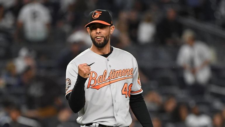 Baltimore Orioles relief pitcher Jorge Lopez reacts at the end...