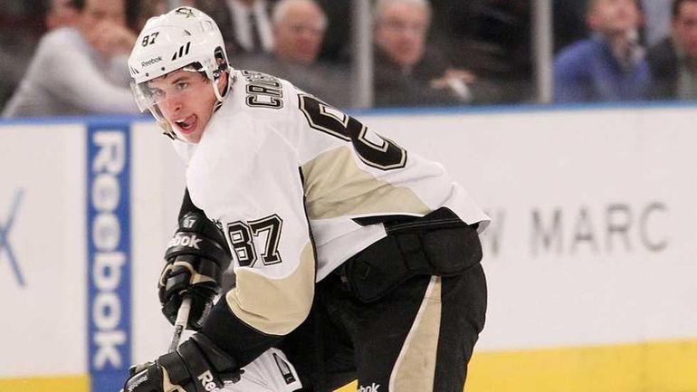 Sidney Crosby of the Pittsburgh Penguins skates with the puck...