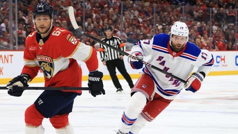 Blake Wheeler of the Rangers skates against Brandon Montour of the...