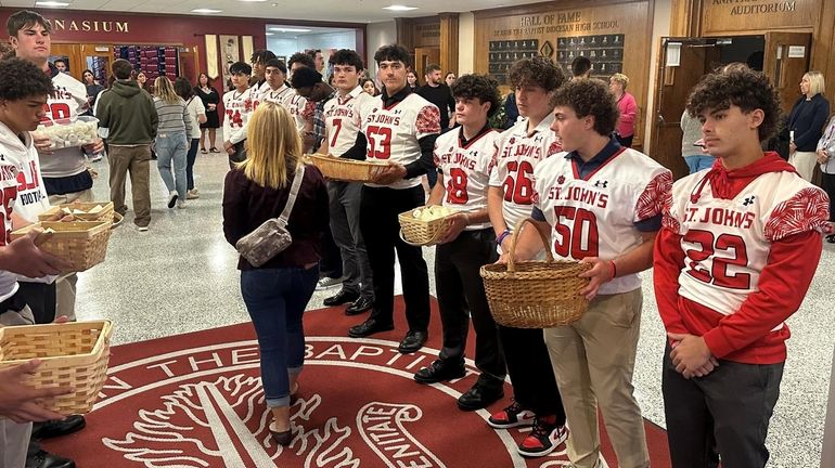 Students at a vigil on Monday at St John the Baptist...