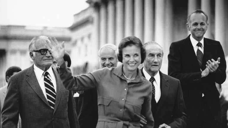 Sandra Day O'Connor waves as she arrives at the Capitol...