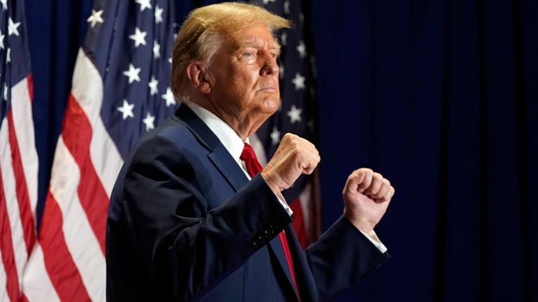 Republican presidential candidate former President Donald Trump gestures at a...