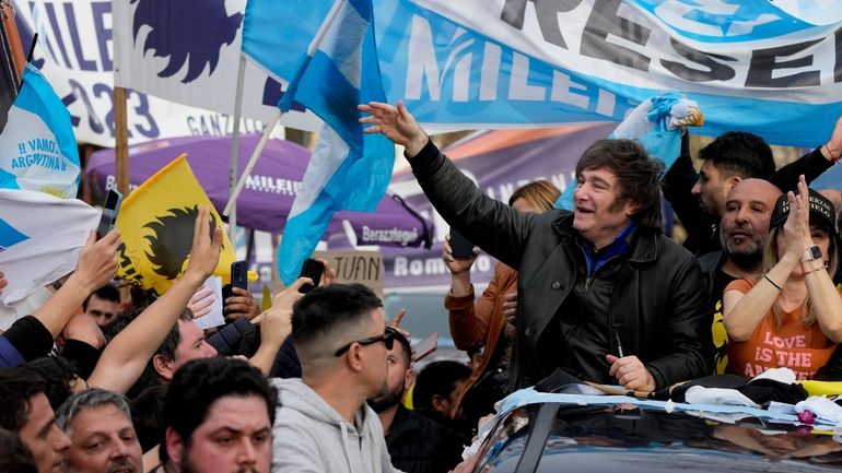 Presidential hopeful of the Liberty Advances coalition Javier Milei, waves...