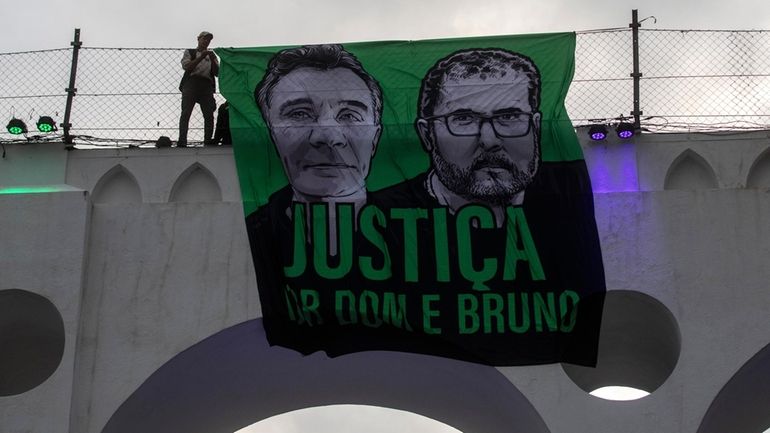 A sign that reads in Portuguese "Justice for Dom and...