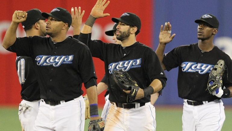 Toronto Blue Jays' Vernon Wells, left to right, Jose Bautista,...