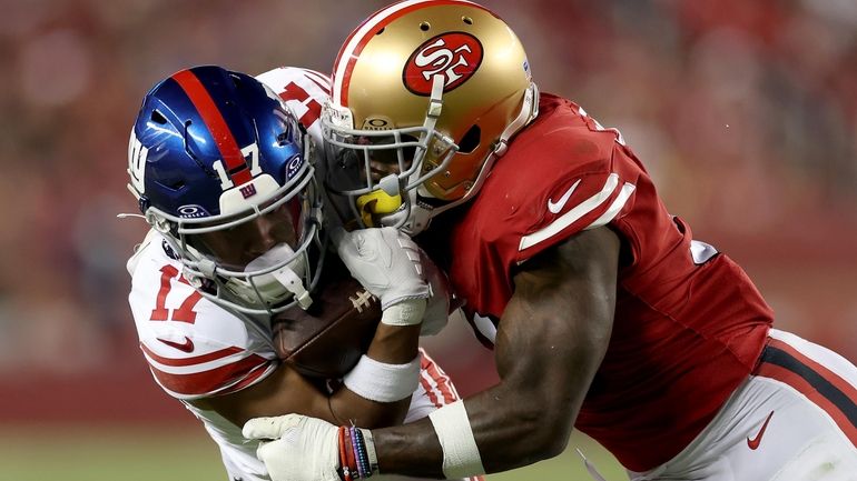 Wan'Dale Robinson #17 of the Giants is tackled by Tashaun Gipson...