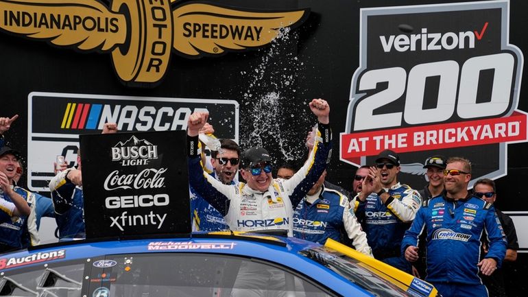 Michael McDowell celebrates after winning the NASCAR Cup Series auto...