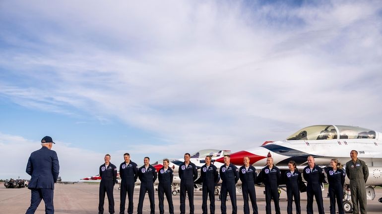 President Joe Biden greats a group of Thunderbird pilots after...