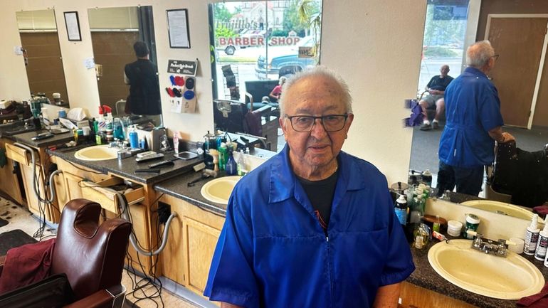 Eli Trujillo poses inside his barbershop in Cheyenne, Wyo., Thursday,...